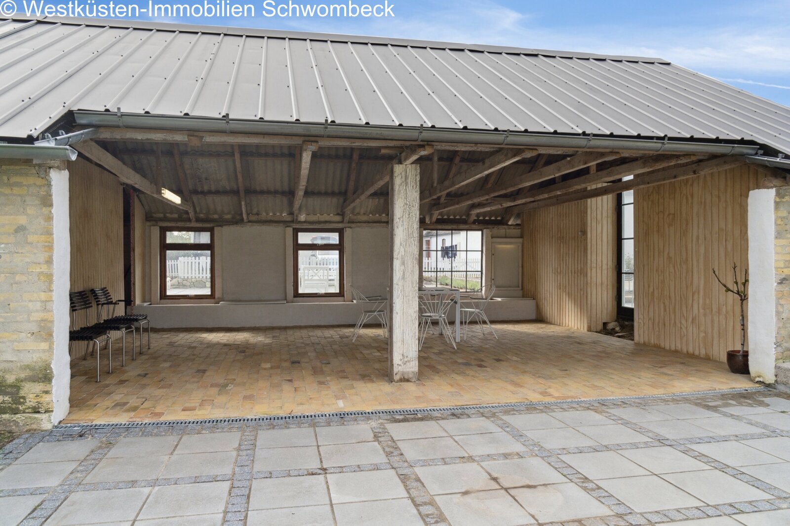 Überdachte Terrasse mit Stahlkonstruktion und großflächigen Verglasungen